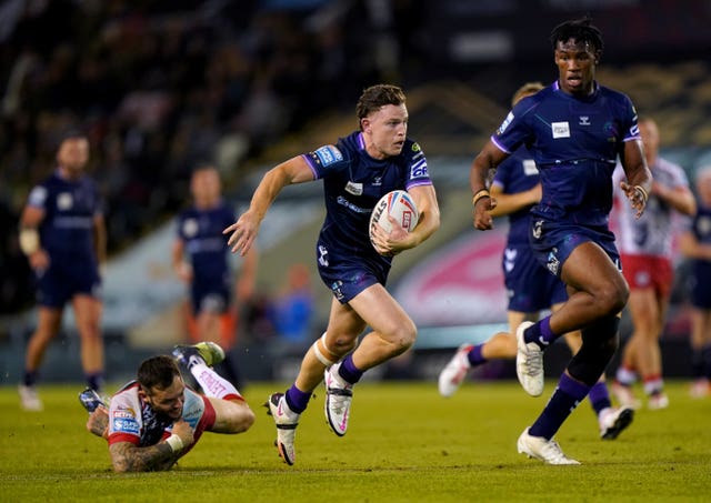 Wigan's Jai Field, centre, runs at the Leigh defence