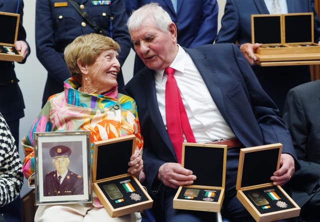 Bernadette O’Dea, holding a photograph of her late husband Assistant Commissioner Edward O’Dea along with his Bronze Scott Medal which was awarded posthumously, in conversation with Bronze Scott Medal recipient Detective Chief Superintendent Patrick Sheil at a ceremony for deceased, retired and serving members of An Garda Siochana with Scott Medals for bravery, at Walter Scott House, Dublin
