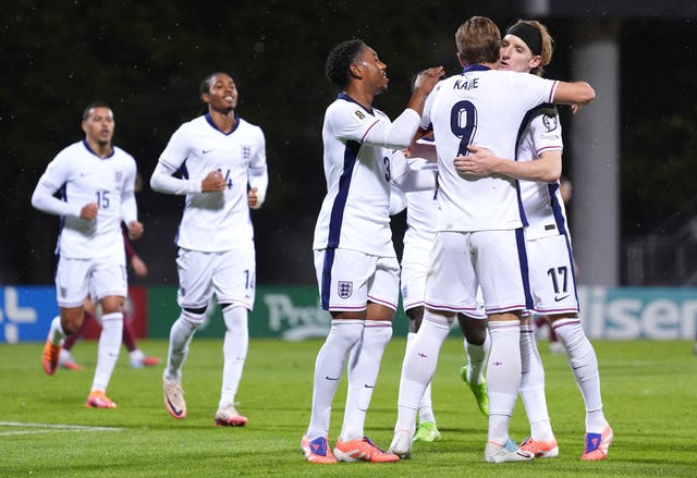 Captain Harry Kane (second right) celebrates scoring England's third goal against Latvia