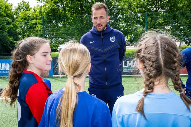 England captain Harry Kane speaks to schoolchildren