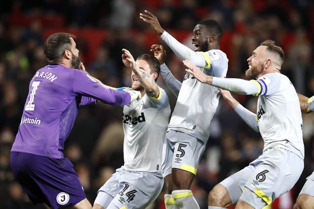 Derby players celebrate winning at Old Trafford