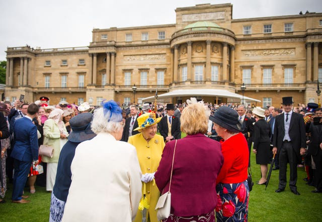 The Queen greeting guests during a garden party at Buckingham Palace