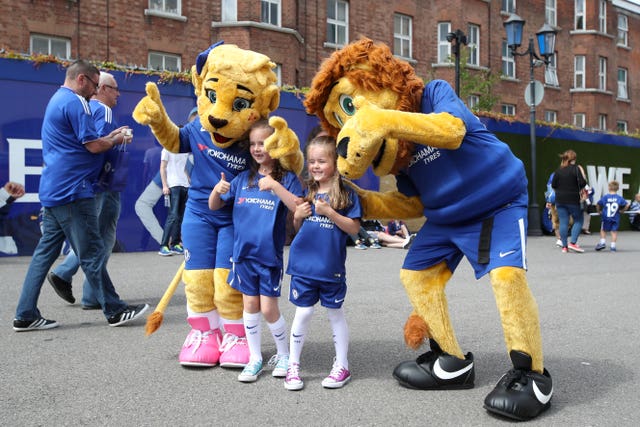 Young Chelsea supporters pose with club mascots before a game against Burnley 