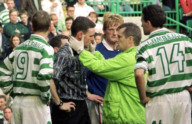 Referee Hugh Dallas receives medical attention after being struck with a coin at the Parkhead 'shame game'