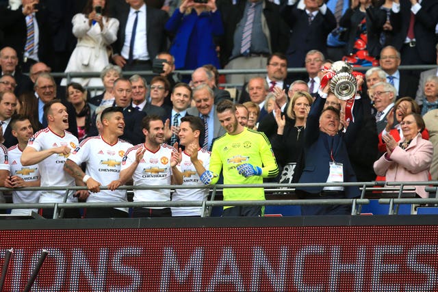 Louis van Gaal, right, pictured lifting the FA Cup for United