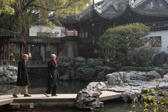 Prime Minister Theresa May and her husband Philip walk around the Yu Yuan Temple Garden in Shanghai (Stefan Rousseau/PA)