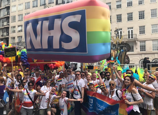 Guy’s and St Thomas’ NHS Foundation Trust staff members celebrating the NHS rainbow badge scheme developed by Evelina London Children's Hospital, during the Pride in London Parade