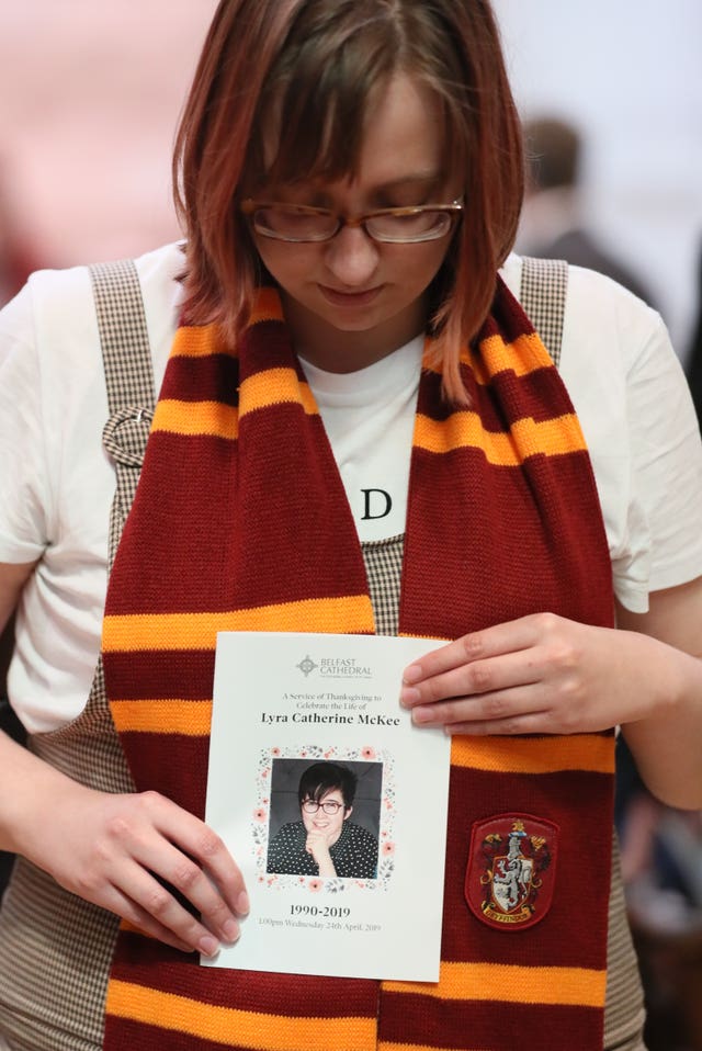 A mourner in a Harry Potter scarf