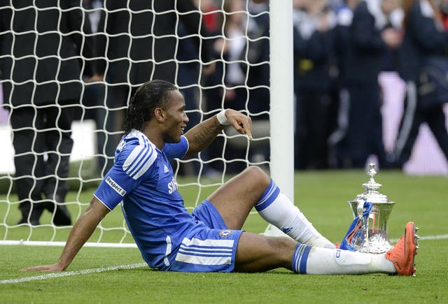 Didier Drogba, who scored Chelsea's second goal in their 2-1 win against Liverpool in the 2012 final, has a rest during post-match celebrations 