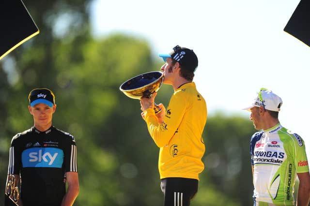 Sir Bradley Wiggins, centre, won the 99th Tour de France ahead of team-mate Chris Froome