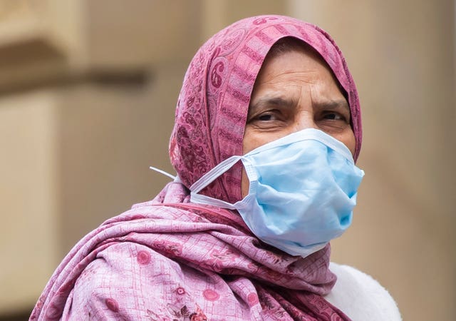 A member of the BAME community wearing a face mask