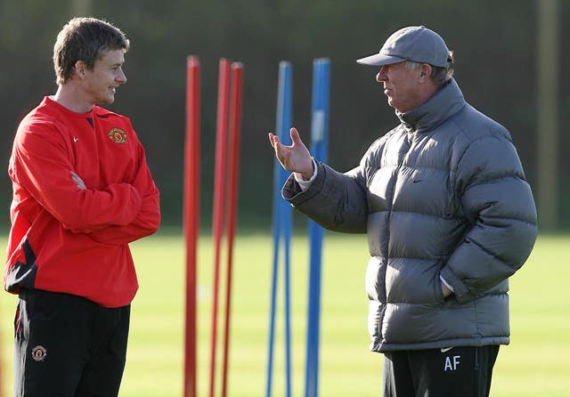 Sir Alex Ferguson talks with Solskjaer during a training session at Carrington 