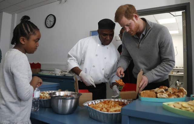 Prince Harry helped serve up pasta during the visit to the centre