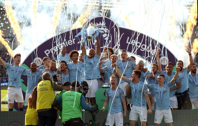 Manchester City's Vincent Kompany (centre) lifts the Premier League trophy at Brighton last year