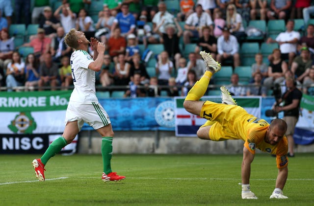 George Saville, left, reacts as Sergei Lepmets saves his shot