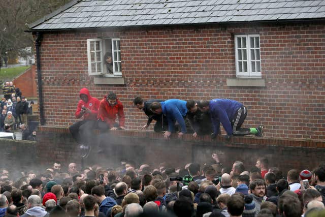 Some players tried to get a better view of proceedings (Aaron Chown/PA)