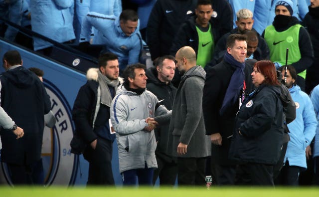Pep Guardiola shakes hands with Chelsea assistant Gianfranco Zola as Chelsea manager Maurizio Sarri walks down the tunnel