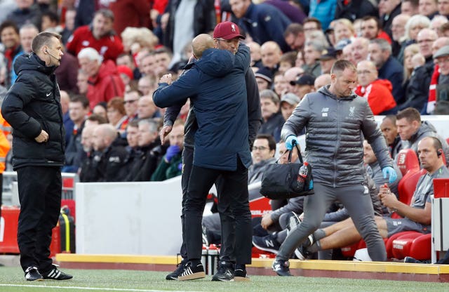 Jurgen Klopp and Pep Guardiola embrace before kick-off at Anfield