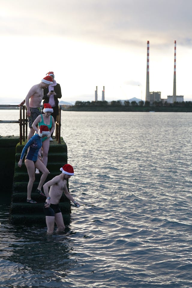 People descend steps into the sea