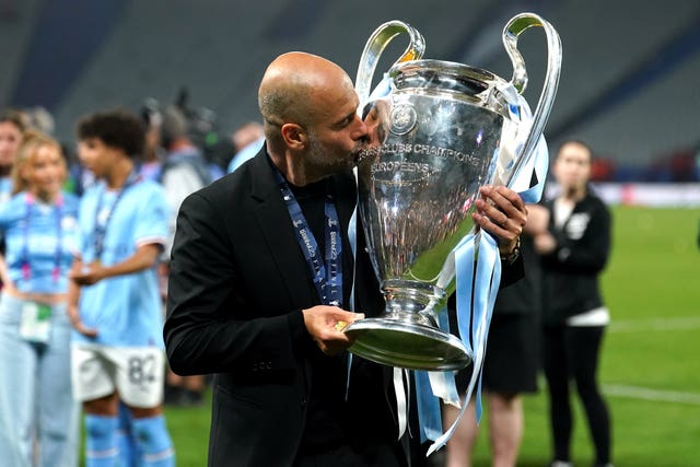 Manchester City manager Pep Guardiola kisses the Champions League trophy