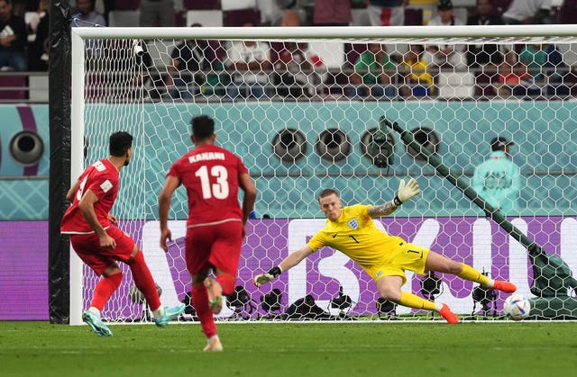 Iran’s Mehdi Taremi beats England goalkeeper Jordan Pickford from the penalty spot