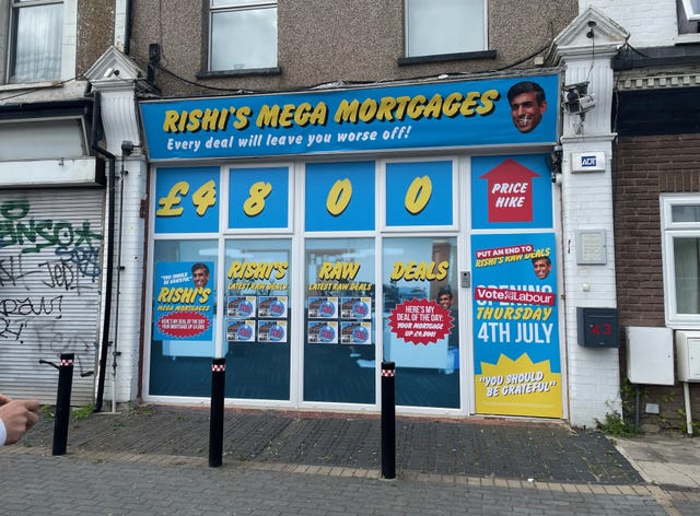 A blue and yellow shop front with signage reading Rishi's Mega Mortgages