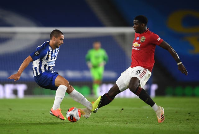 Brighton's Neal Maupay, left, and Manchester United's Paul Pogba battle for the ball 