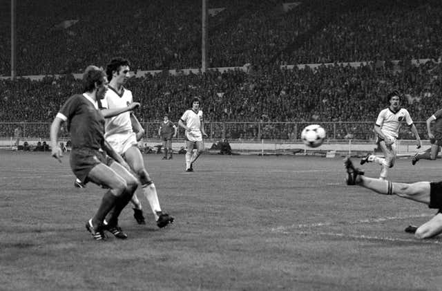 Kenny Dalglish chips the ball over Brugge goalkeeper Birigir Jensen 