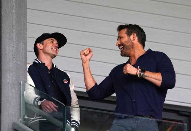 Rob McElhenney and Ryan Reynolds pictured in the stands at a Wrexham match