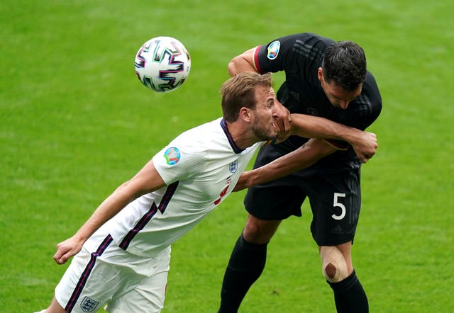 England's Harry Kane and Germany's Mats Hummels fight for the ball in the first half