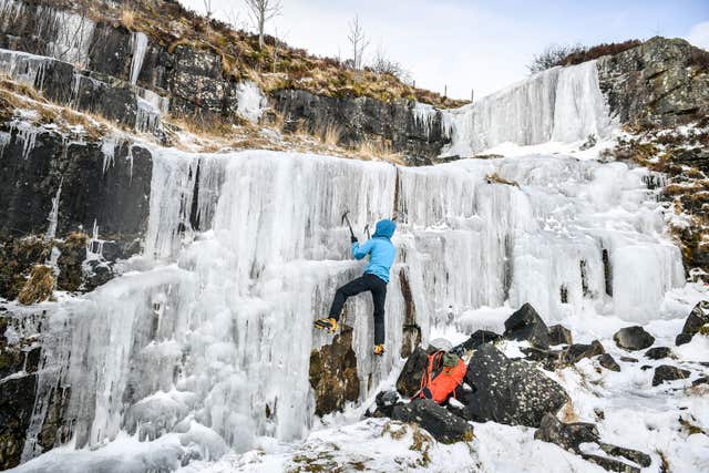 An ice climber tackles a frozen waterfall high up in Brecon Beacons National Park (Ben Birchall/PA)