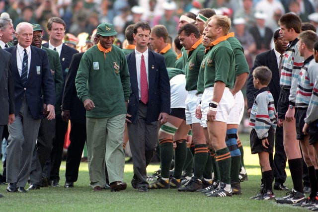 South Africa president Nelson Mandela walks past Springboks captain Francois Pienaar before the 1995 World Cup final in South Africa. Rugby would turned professional two months later