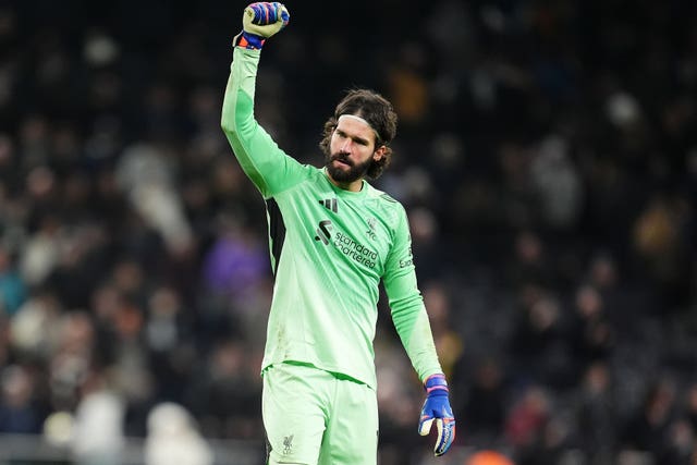 Liverpool goalkeeper Alisson Becker raises his right fist in celebration