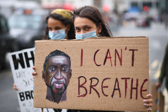 People hold banners during the protest (Stefan Rousseau/PA Wire)