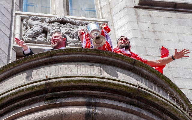 Aberdeen manager Jimmy Thelin, left, and captain Graeme Shinnie lift the Scottish Cup on the balcony of Aberdeen Town House