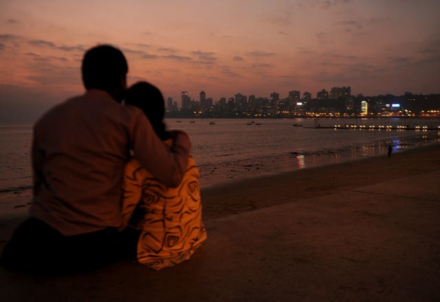A couple watch the sunset