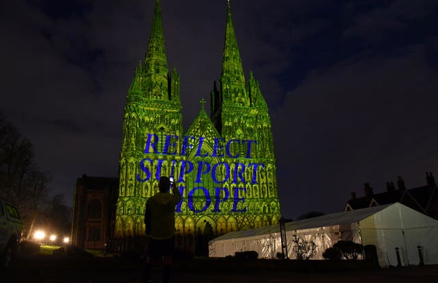 Lichfield Cathedral in Staffordshire is illuminated with the words Reflect, Support, Hope during the National Day of Reflection
