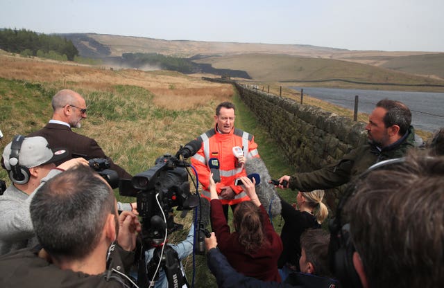 Phil Nelson speaks to the media near Delph, Greater Manchester