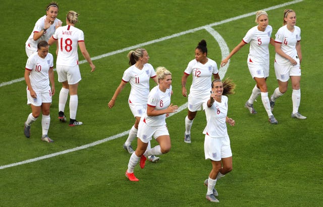 England players celebrate the opening goal by Jill Scott (right)