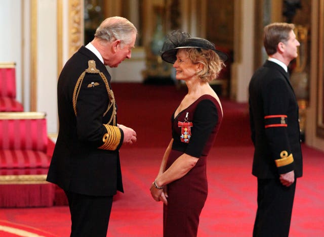Annamarie Phelps is made a Commander of the Order of the British Empire (CBE) by the Prince of Wales during an Investiture ceremony at Buckingham Palace