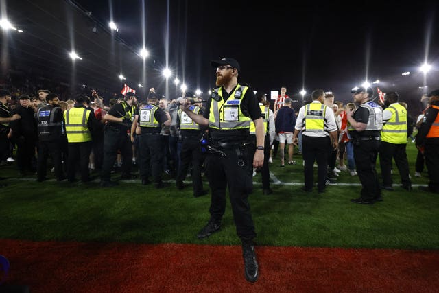 Police and ground staff attempt to separate the fans at St Mary''s