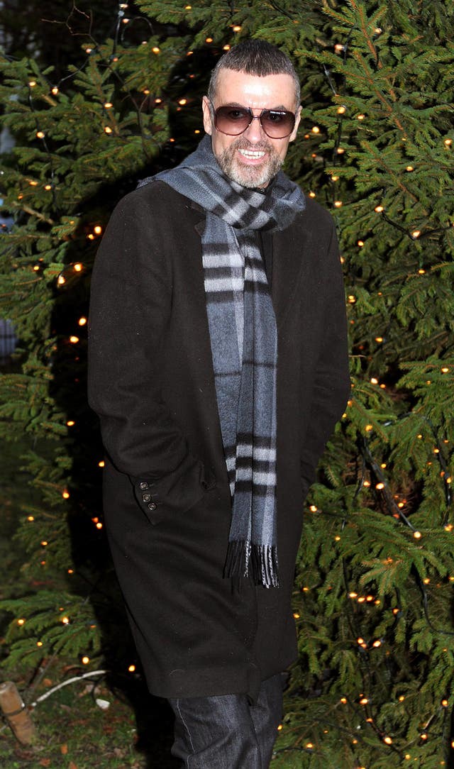 George Michael walking outside, wearing a scarf and coat