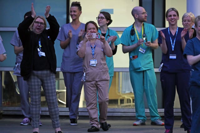The Queen has described the applause for care and essential workers - being observed here by staff from the Royal Liverpool University Hospital - as an