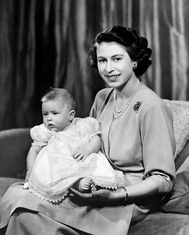 Princess Elizabeth with her baby son Prince Charles in a private room at Buckingham Palace in April 1949