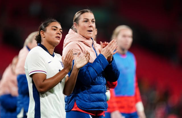 Jess Carter, left, and Mary Earps applaud the England fans