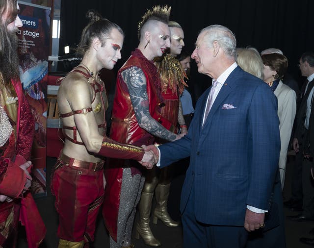 The King and Queen Consort (hidden) speak with the German Eurovision song contest entry Lord of the Lost
