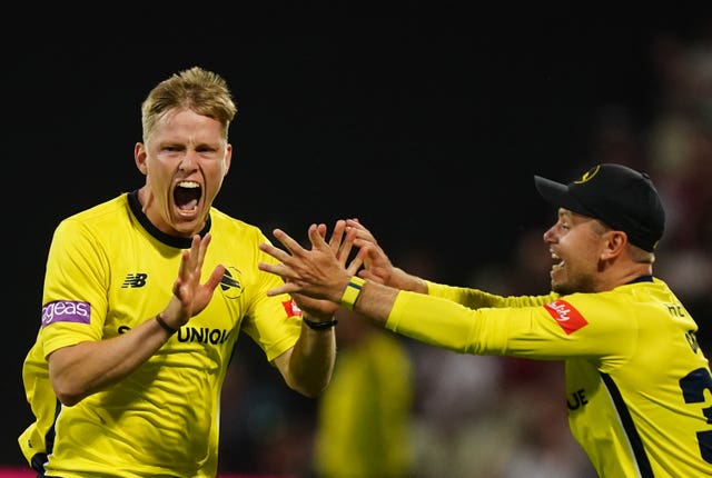 Nathan Ellis, left, celebrates after Hampshire beat Lancashire by one run to lift the Vitality Blast trophy after a final-ball thriller in Birmingham