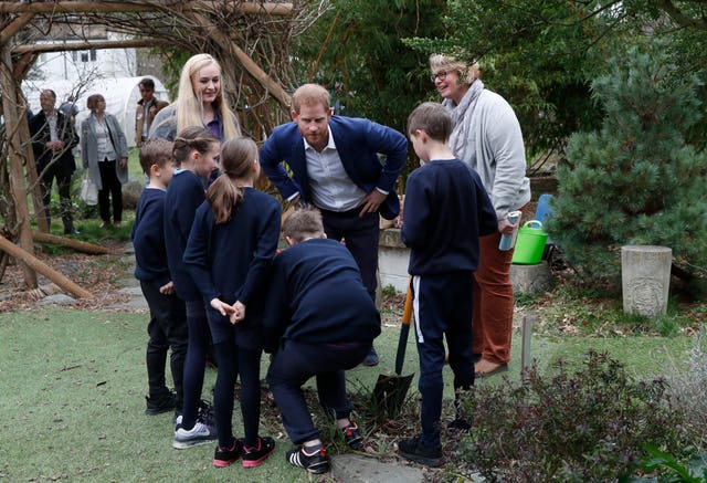 Harry helped plant a cherry tree at the school