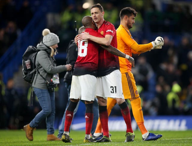 Ashley Young and Nemanja Matic celebrate after the final whistle at Chelsea on Monday