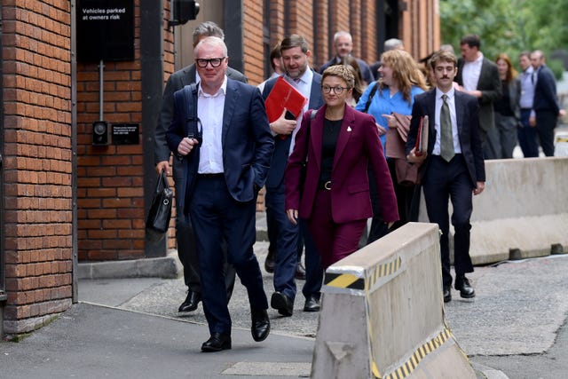 Group of people walking along a pavement